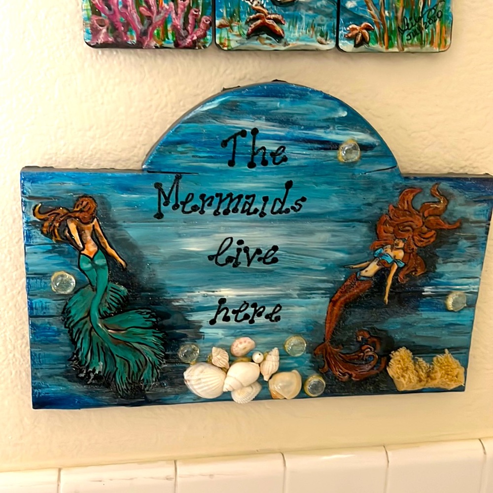Handcrafted and painted wood board The Mermaids live Here”